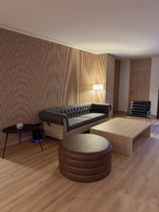 Sofá gris, mesa de madera y silla en un ambiente moderno